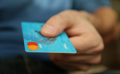 person holding debit card