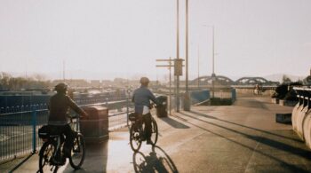 cyclists riding on the street at dawn