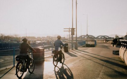 cyclists riding on the street at dawn