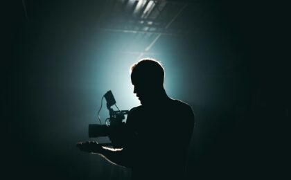 silhouette of man standing in front of microphone